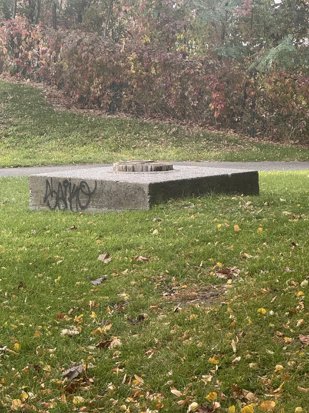 The concrete base and stump of the Leonard totem pole.